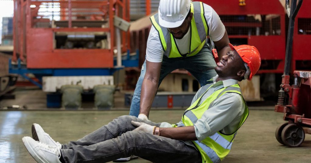 Man lying on the ground after a workplace accident